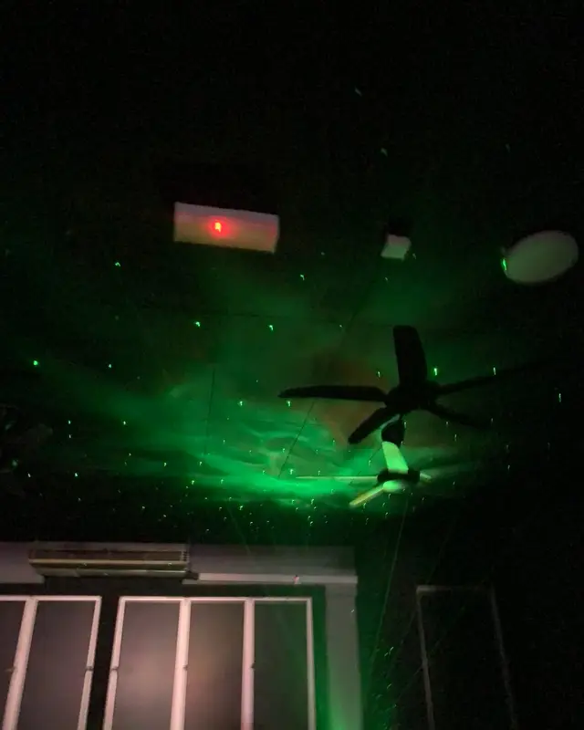 Green laser stars across the ceiling, above the windows.