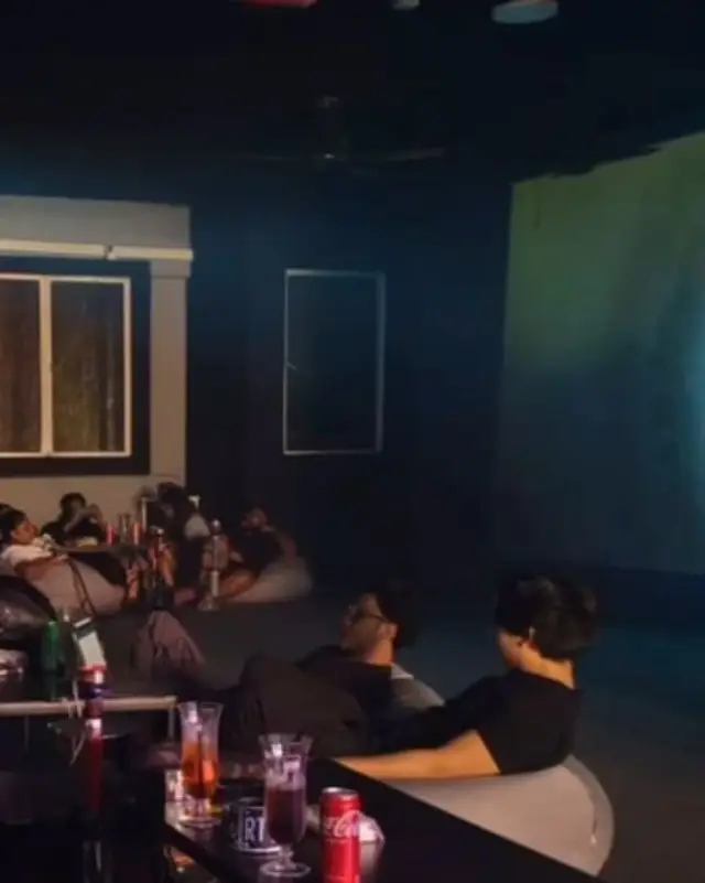 Movie night: guests on bean bags in front of the big screen.