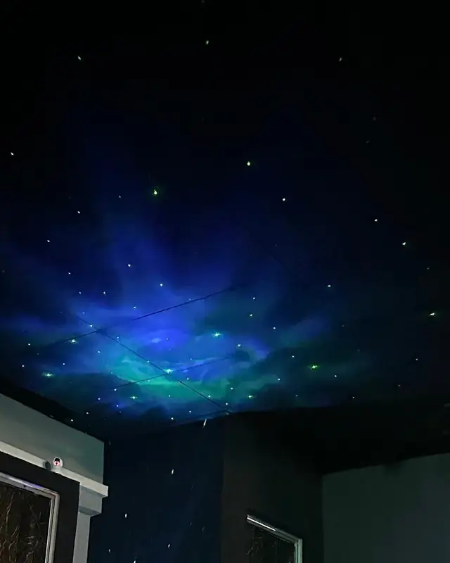 Stars and a blue glow projected across the ceiling.